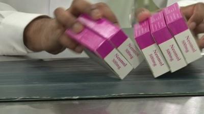 Boxes of drugs being sorted in a factory