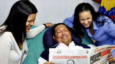 Hugo Chavez with his daughters in a Cuban hospital