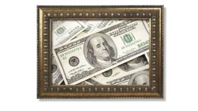 Hundred dollar bills in a brass frame