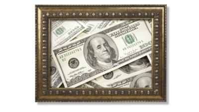 Hundred dollar bills in a brass frame