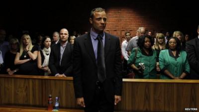 Oscar Pistorius awaits the start of court proceedings in the Pretoria Magistrates court