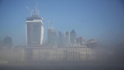 The City of London financial district emerges from early morning fog