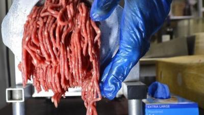 Beef being put through a mincer