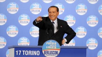 Former Italian Prime Minister Silvio Berlusconi gestures during a political rally in Turin