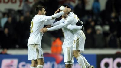 Swansea City's Leon Britton (right) celebrates at the final whistle with teammates during their semi-final second leg match at the Liberty Stadium in Swansea