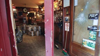 Smashed doors at The Smoking Dog pub