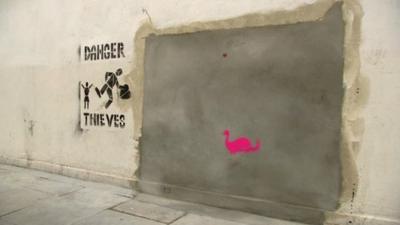 Empty space left by Banksy mural