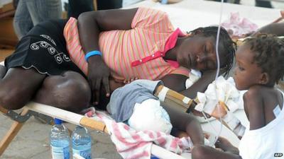 Sick victims and relatives receive treatment in St. Marc, north of Port-au-Prince on October 24, 2010