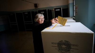 Woman casts her vote at polling station