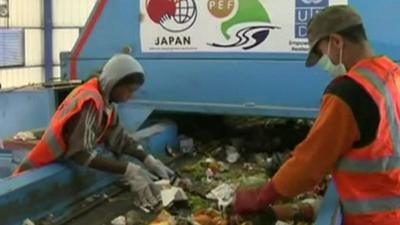 Workers sorting rubbish through in a new recycling plant