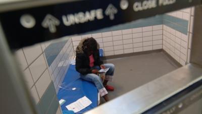 Young woman in prison cell