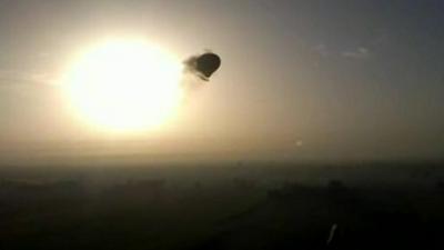 Balloon trailing smoke