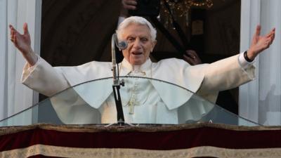 Pope Benedict XVI greets the crowd from the window of the Pope's summer residence of Castel Gandolfo