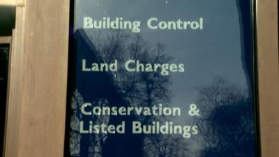 A sign for council departments outside a council building