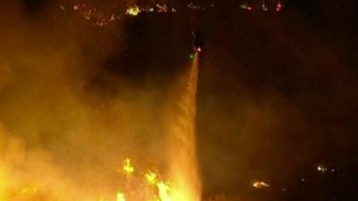Helicopter pours water to extinguish a wildfire