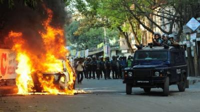 Car burns during clashes between police and activists in Dhaka. 2 March 2013