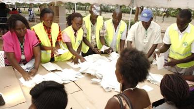 Poll officials count ballots