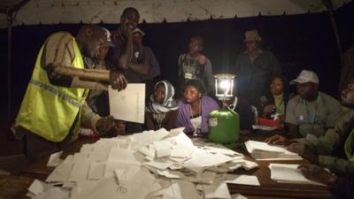 Poll officials count ballots