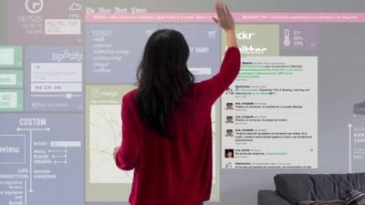 A woman browses the internet on a wall