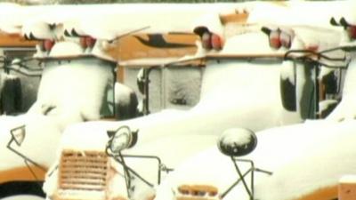 US school buses covered in snow