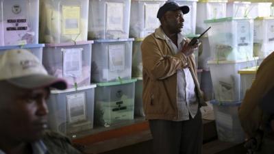 A policeman stands in front of ballot boxes in a tallying centre in Kenya