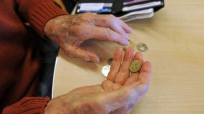 Pensioner holding change