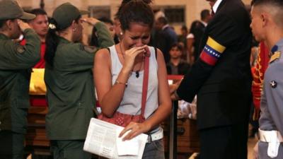 Woman reacting as she pays tribute to the late Venezuelan President Hugo Chavez