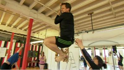 The BBC's Mike Bushell tries pole fitness