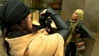 Artist Sara Shamsavari photographs a woman wearing a hijab