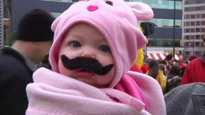 Baby wearing fake moustache