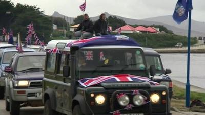 Cars decorated with flags in Port Stanley.