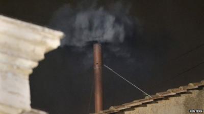 Black smoke rises from the chimney on the roof of the Sistine Chapel in Vatican City