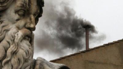 Black smoke billows from the chimney on the roof of the Sistine Chapel