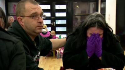 An unemployed woman in Hull comforted by her husband