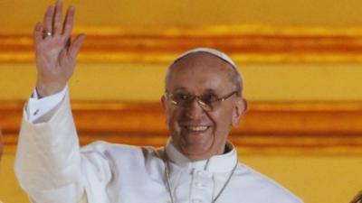 Pope Francis waves to the crowd from the central balcony of St. Peter's Basilica at the Vatican