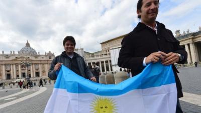 Two men brandish the Argentine flag on St Peter's Square, Rome, 15 March