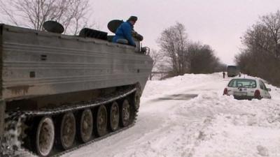 Tank and car trapped in snow