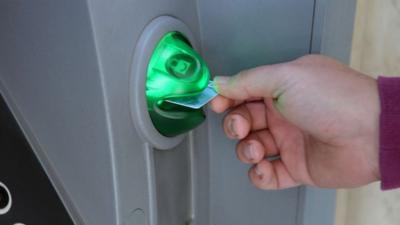 A man withdraws money from an ATM in the Cypriot capital of Nicosia