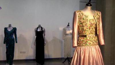 Four of Diana's dresses on display