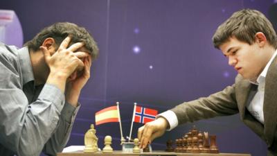 Magnus Carlsen (right) playing chess