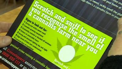 A cannabis scratch and sniff card being opened