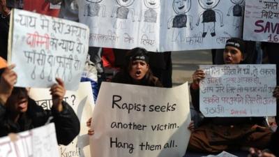 Indian protestors holds placards as they shout slogans during a protest against last month"s gang rape and murder of a student, in New Delhi on January 29, 2013.