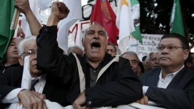 Protesters shout slogans during an anti-bailout rally