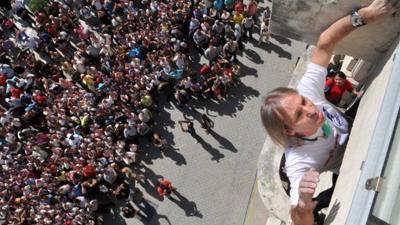 Alain Robert climbing a building