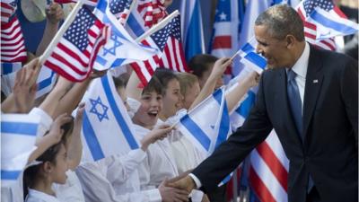 President Obama greets children waving US and Israeli flags