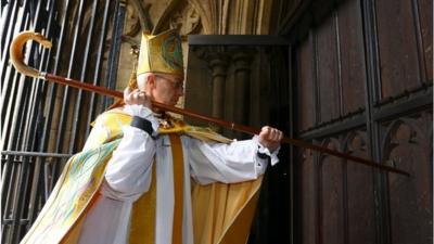 The Most Reverend Justin Welby, strikes three times on the West Door of Canterbury Cathedral