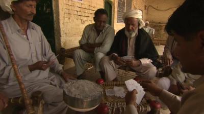 Men playing cards in Pakistan