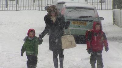 Mother and children in the snow