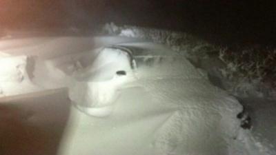 Car part-buried in snowdrift