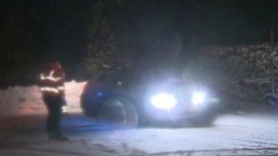 Rescue worker approaching stranded car